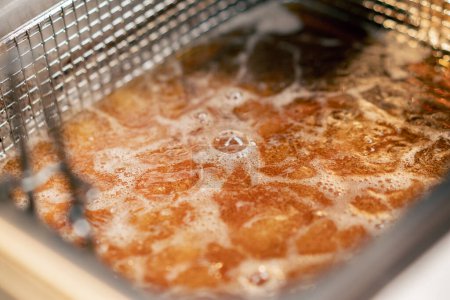 Photo for Close-up frying in oil deep-frying potatoes and sweet potatoes boil oil - Royalty Free Image