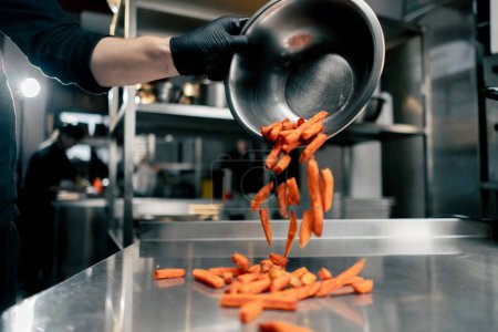 Photo for Close-up of sweet potato fries spilled onto the cooks table before cooking - Royalty Free Image