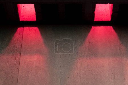 Photo for Close-up of a part of a wall with square slots with a pink neon glow abstraction - Royalty Free Image