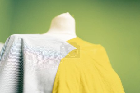 Photo for Close-up of a mannequin in a sewing workshop with fabric pins attached to it - Royalty Free Image