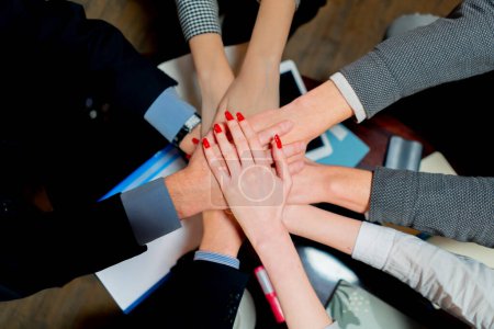 Photo for Close-up of the hands of office workers guys and girls hands folded in commanding manner - Royalty Free Image