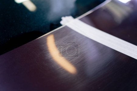 Photo for Close-up at a service station a metal part from a car has already been polished - Royalty Free Image