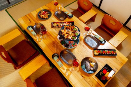 Photo for In a Japanese restaurant a traditional Japanese room for lunch a table set with fish dishes - Royalty Free Image