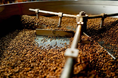 Photo for Close-up of a coffee roasting factory inside a drum roasting stirring coffee - Royalty Free Image