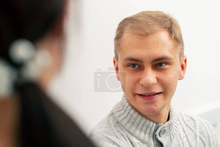 Photo for Close up in a private clinic in a testing room a doctor monitors a patient after an injection he smiling - Royalty Free Image