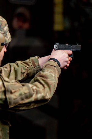 close up of a military trainer taking aim for a shot at a professional shooting range
