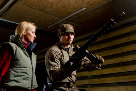 At a professional shooting range a military trainer tells a girl how to properly handle NATO weapons