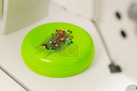 Photo for Close-up in a sewing workshop a pin cushion is completely stuffed with needles and pins - Royalty Free Image