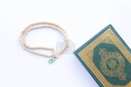 The Qur'an and Tasbih are used by Muslims for worship. On a white background