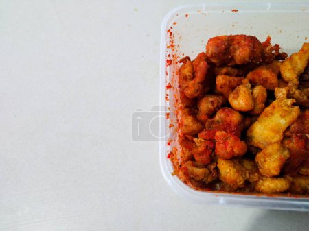 Balado spiced fried chicken on a white background