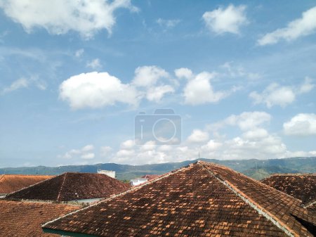 Rows of house roofs with sky background