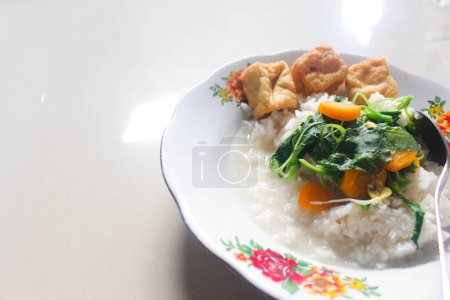 Breakfast menu of vegetable rice with fried tofu as a side dish