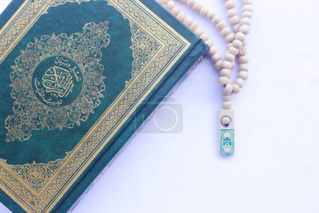 The Qur'an and Tasbih are used by Muslims for worship. On a white background