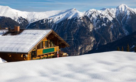 A small hut stands on a high point in the mountains, Austrian Alps. High quality photo