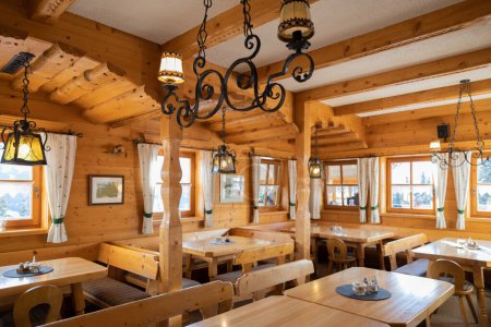 Téléchargez les photos : Beautiful design of the mountain restaurant, decorated in the national Austrian style. High quality photo - en image libre de droit