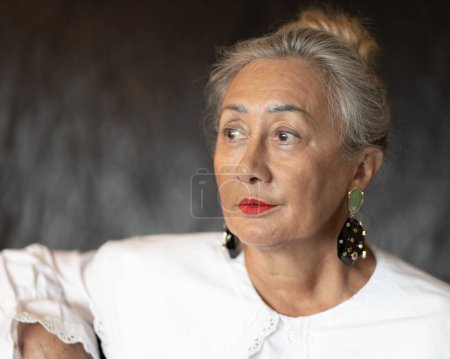Téléchargez les photos : Studio portrait of a lady with raised hair and large earrings. quality photo - en image libre de droit