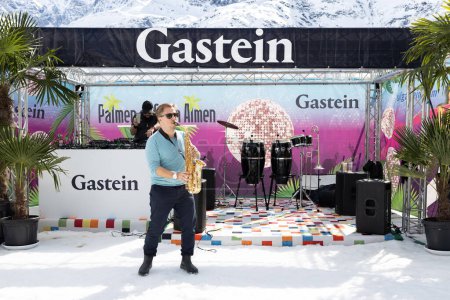 Photo for AUSTRIA, SPORTGASTEIN - March 18, 2023: Event Palmen auf den Almen, musician with saxophone in open air. High quality photo - Royalty Free Image