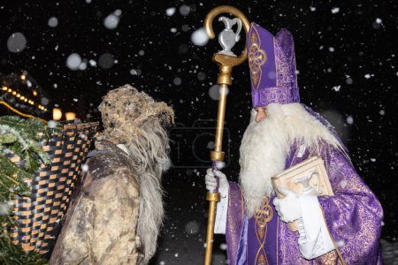 Photo for St. Nicholas and the bearer of a box with gifts in the Christmas procession of the Krampus, Austria, Gastein. High quality photo - Royalty Free Image