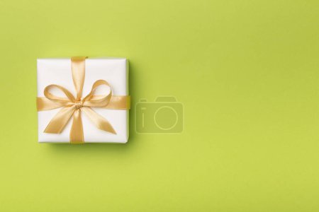 White gift box on color background, top view.