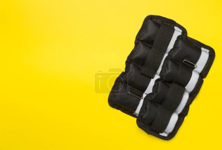 Photo for Fitness wrist and ankle weights on color background, top view - Royalty Free Image