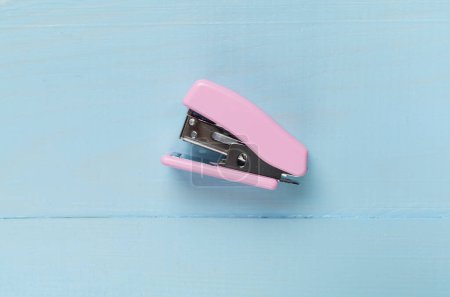 Photo for Pink stapler on wooden backgroung, top view - Royalty Free Image