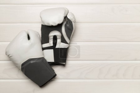 Photo for Martial arts gloves on wooden background, top view - Royalty Free Image