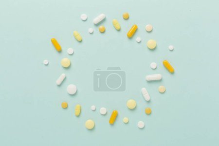 Photo for White pills on blue background, top view - Royalty Free Image
