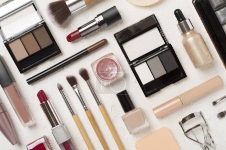 Téléchargez les photos : Pose plate avec des produits de maquillage et des outils sur fond de béton - en image libre de droit