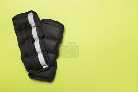 Photo for Fitness wrist and ankle weights on color background, top view - Royalty Free Image