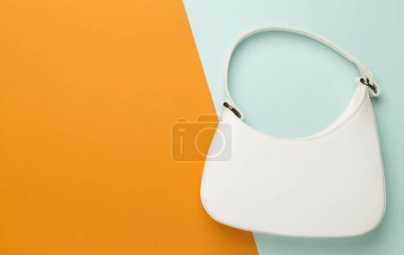 Trendy woman bag on colorful background, top view