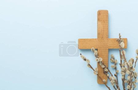 Cross with willow branches on color background, top, view. Palm Sunday concept