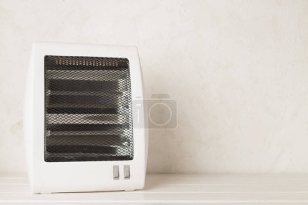 Photo for Portable electric halogen heater on table - Royalty Free Image