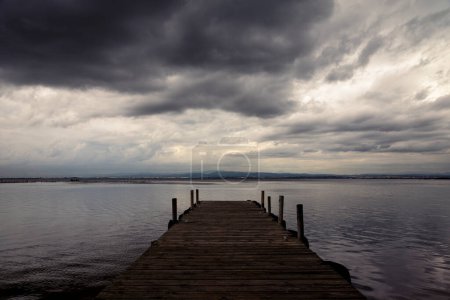 Photo for Play of lights with the clouds over the Albufera pier - Royalty Free Image
