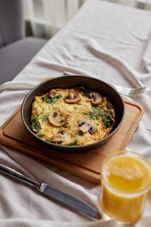 shakshuka with mushrooms, omelette, scrambled eggs with mushrooms in a frying pan, breakfast concept