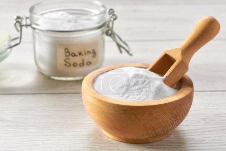 Photo for Sodium bicarbonate on a white wooden table, selective focus. Environmentally friendly detergent - baking soda on a white wooden table. - Royalty Free Image