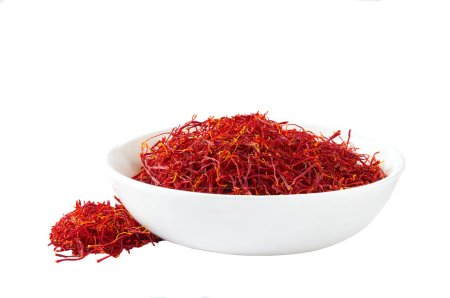 Photo for Saffron thread in a ceramic plate isolated on white background. - Royalty Free Image