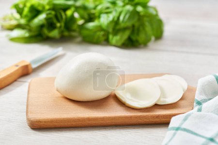 Photo for White balls of soft Italian cheese mozzarella buffalo on a kitchen table, selective focus. - Royalty Free Image