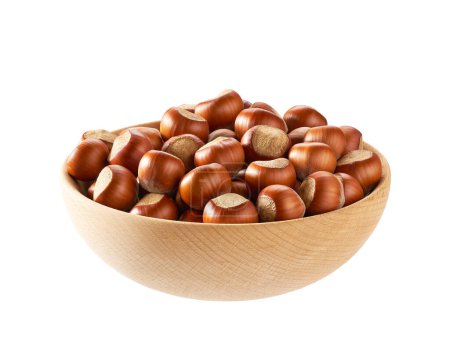 Foto de Unpeeled hazelnuts in a wooden bowl isolated on white.Front view. - Imagen libre de derechos