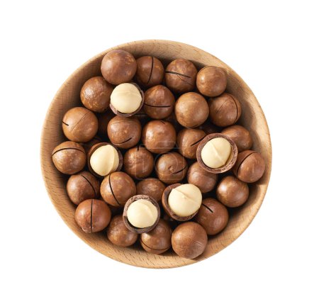 Foto de Wooden plate with organic macadamia nuts  isolated on white background, top view. - Imagen libre de derechos
