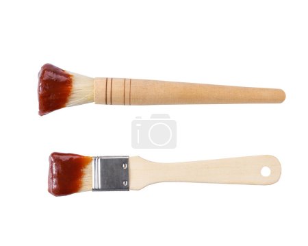 Photo for Wooden culinary brush dipped in barbecue sauce isolated on a white background. Basting brush with barbecue sauce isolated.  bbq sauce and brush. - Royalty Free Image