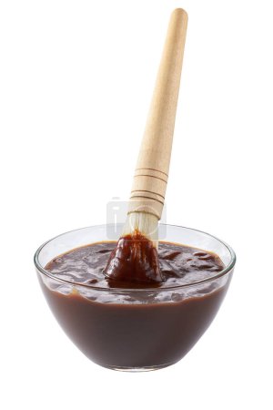Photo for Barbecue sauce in bowl with barbecue brush isolated on a white background. - Royalty Free Image