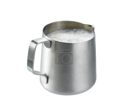 Téléchargez les photos : Stainless steel pitcher with whipped milk isolated on white background . stainless steel milk pitcher (foaming jugs) isolated on white background with clipping path. - en image libre de droit