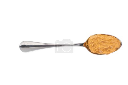 Photo for Peanut creamy paste in a metal spoon isolated on white background,top view. Delicious peanut butter in spoon. - Royalty Free Image