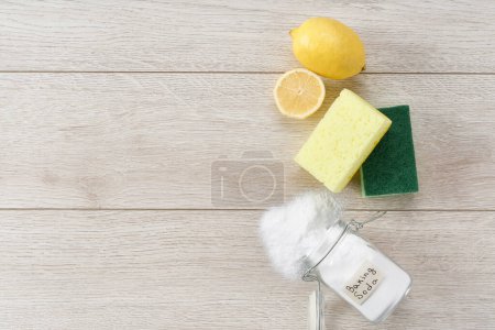 Photo for Non-toxic cleaner, baking soda and lemon on a white kitchen table, copy space for text. - Royalty Free Image