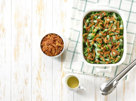 Téléchargez les photos : Casserole de haricots verts avec échalotes frites croustillantes oignons sur une table en bois blanc vue sur le dessus. Alimentation végétarienne estivale saine. - en image libre de droit