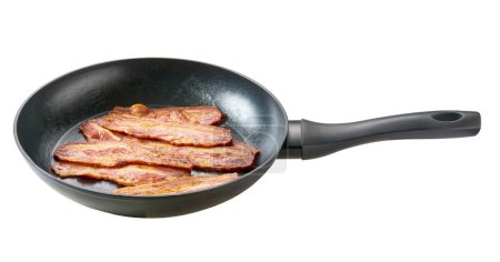 Photo for Hot fried bacon pieces in a skillet isolated on white background, top view. - Royalty Free Image