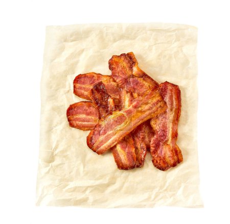 Photo for Cooked bacon rashers on a parchment isolated on white background, top view. fried bacon strips on a baking paper isolated on white background. - Royalty Free Image