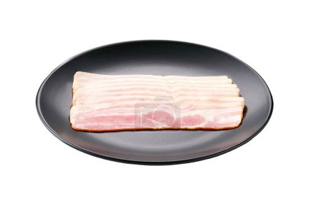 Photo for Slices of smoked bacon in a black plate isolated on white background. - Royalty Free Image