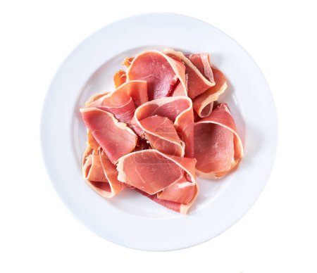 Photo for Spanish jamon cut, parma ham cutting in a  plate isolated on white background. - Royalty Free Image