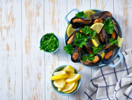 Photo for Delicious seafood mussels with lemon and parsley.Cooking shellfish. - Royalty Free Image